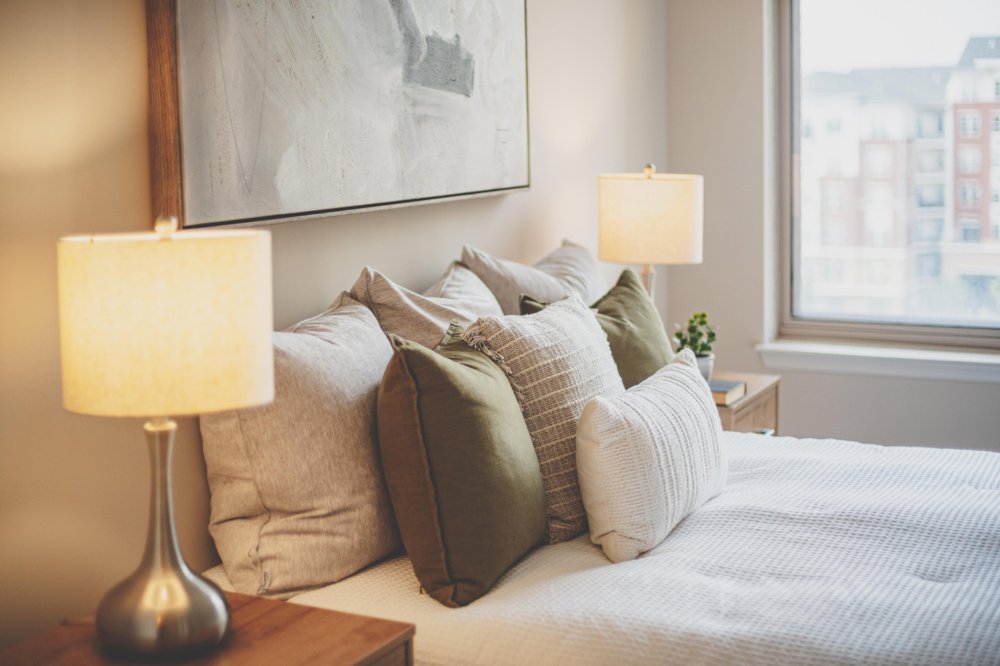 Bed pillows in warm lamp glow
