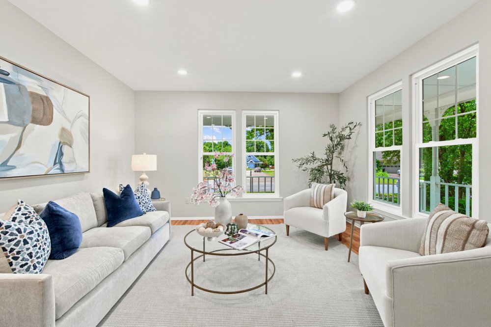 Staged living room with two sofas and navy accents