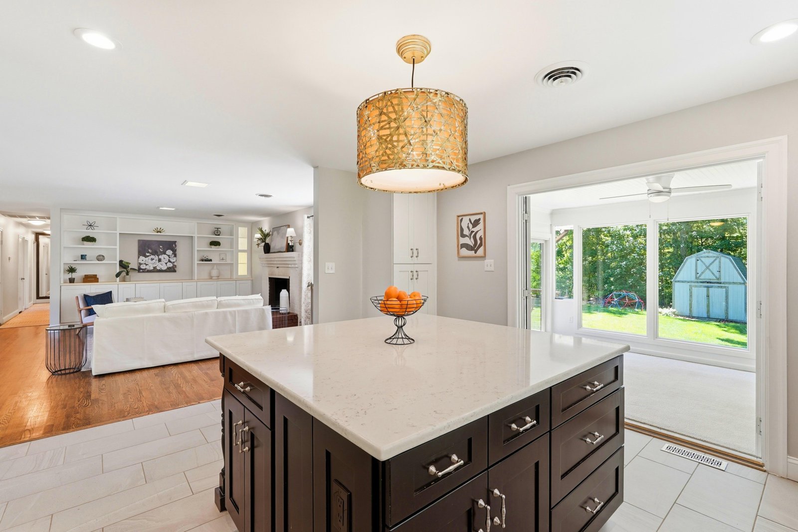 Kitchen with dark island and gold pendant