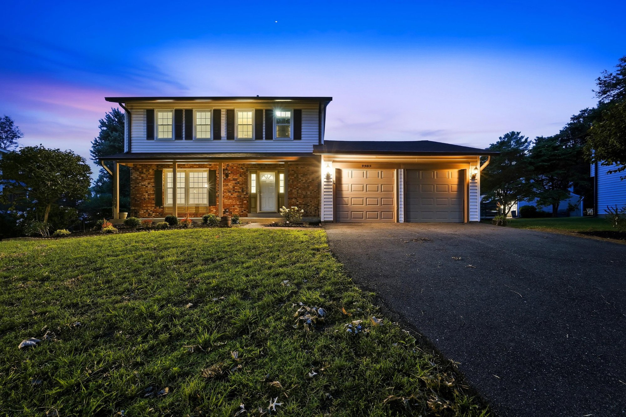 Front elevation at twilight under a deep blue sky